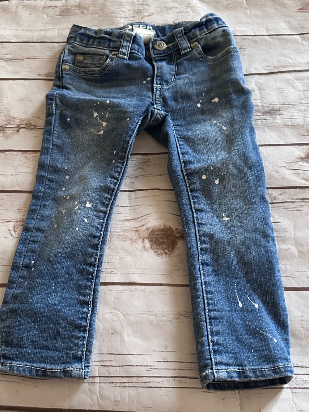 Peek blue denim jeans with white paint splatters